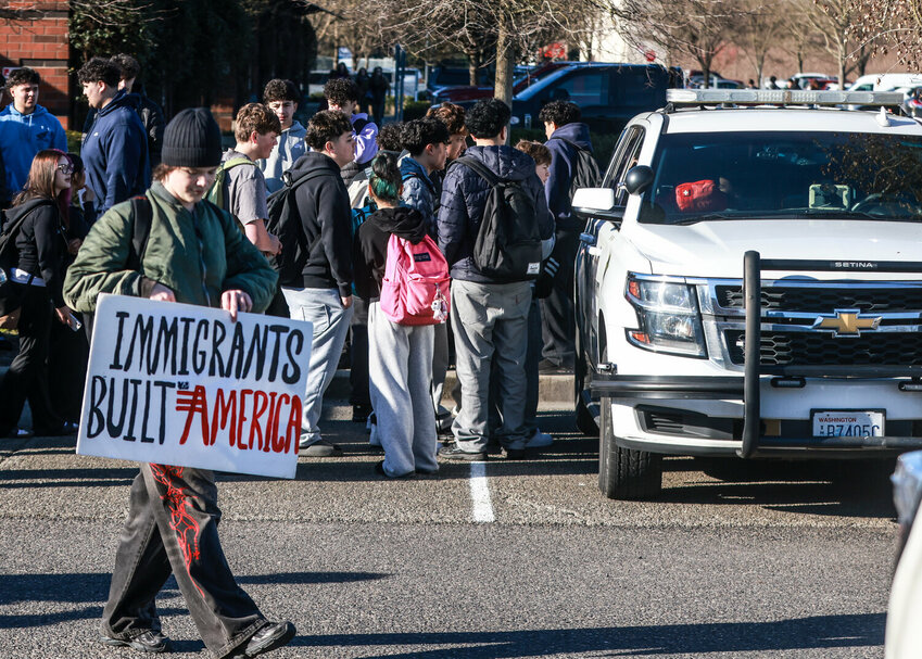 Students crowd a Clark County Sheriff&rsquo;s Office patrol vehicle after a student-aged male was arrested at the Prairie High School student walkout opposing immigration enforcement on Tuesday, Jan. 20.