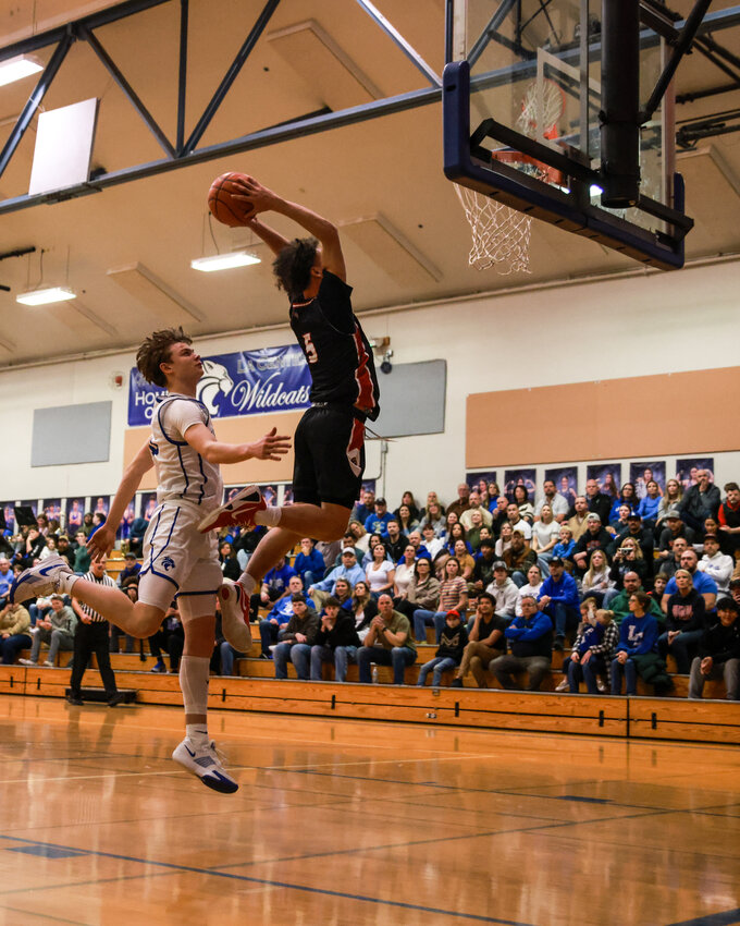 Fort Vancouver&rsquo;s Jaxen Appelt launches by La Center&rsquo;s Brody Mills for one of his many slam dunks in La Center&rsquo;s 78-52 loss to the Trappers on Thursday, Feb. 5.