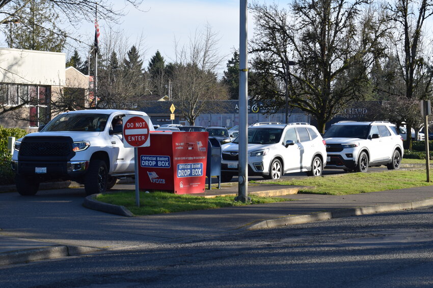 Cars line up to drop off ballots outside the City of Battle Ground&rsquo;s post office on Tuesday, Feb. 10.