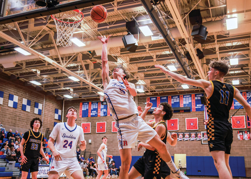 Ridgefield senior guard Jamison McCann slips through traffic for a layup during the Spudders&rsquo; 95-65 win over Aberdeen High School on Thursday, Feb. 12.