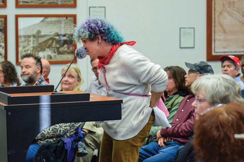 Fia Marie of Clark County makes a wiping motion with paper during a Wednesday, Feb. 11, Clark County Council meeting. The meeting focused on a proposed statement addressing federal immigration enforcement in Clark County.