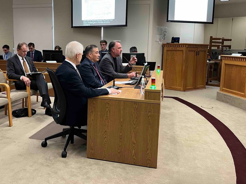 Let&rsquo;s Go Washington leader Brian Heywood, far end of table, testifies before the state Senate&rsquo;s State Government, Tribal Affairs and Elections Committee on Jan. 20, 2026. Center is Secretary of State Steve Hobbs. Next to Hobbs is former Secretary of State Sam Reed. All three testified against Senate Bill 5973, which would impose new restrictions on payments for initiative signature gathering and require at least 1,000 signatures be submitted as part of the filing of a proposed initiative or referendum. In the background, to the left is political activist Tim Eyman. (Photo by Bill Lucia/Washington State Standard)