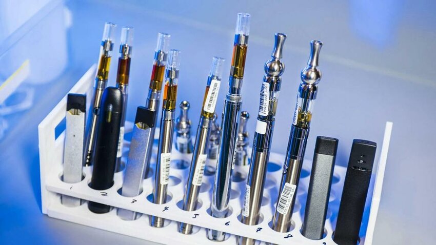 A rack holds various e-cigarettes and vaping pens prepared for testing inside a Centers for Disease Control and Prevention laboratory.