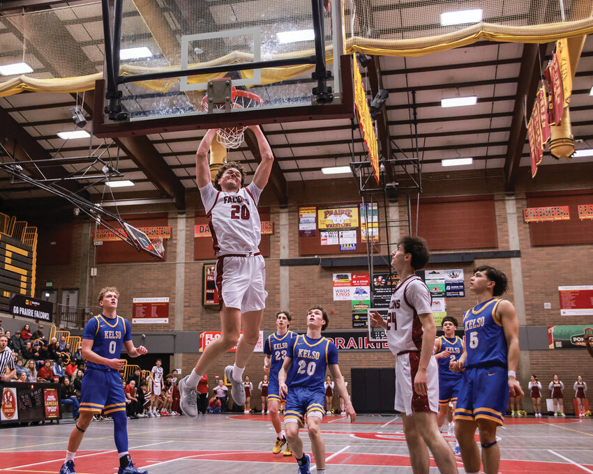 Players from Prairie and Kelso watch as Carson Morningstar scores on a slam dunk in the Falcons&rsquo; 94-55 win over Kelso on Wednesday, Feb. 18, securing a state tournament berth.