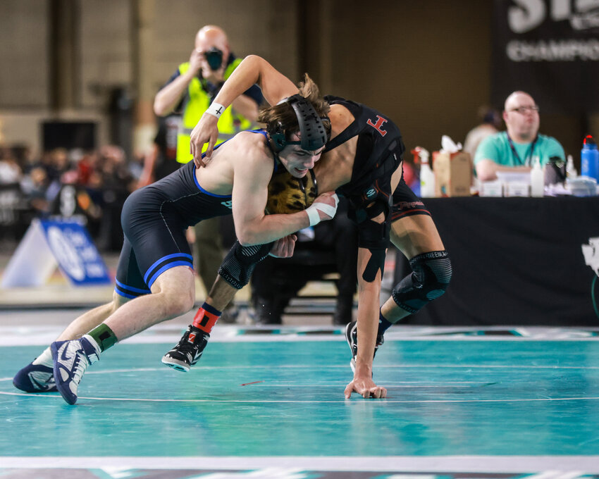 Ridgefield&rsquo;s Mason DesRochers, left, wrestles Toppenish&rsquo;s Anthony Sifuentes in the 2A state finals in the WIAA Mat Classic XXXVII at the Tacoma Dome on Saturday, Feb. 21.