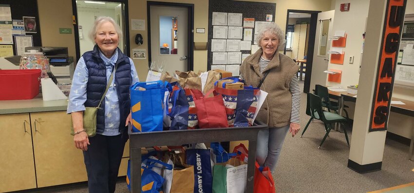 Community volunteers Laura Immel and Victoria Cooper deliver hundreds of dollars&rsquo; worth of essential classroom supplies, purchased through the annual SMART Drive organized by We Love Rainier WA.