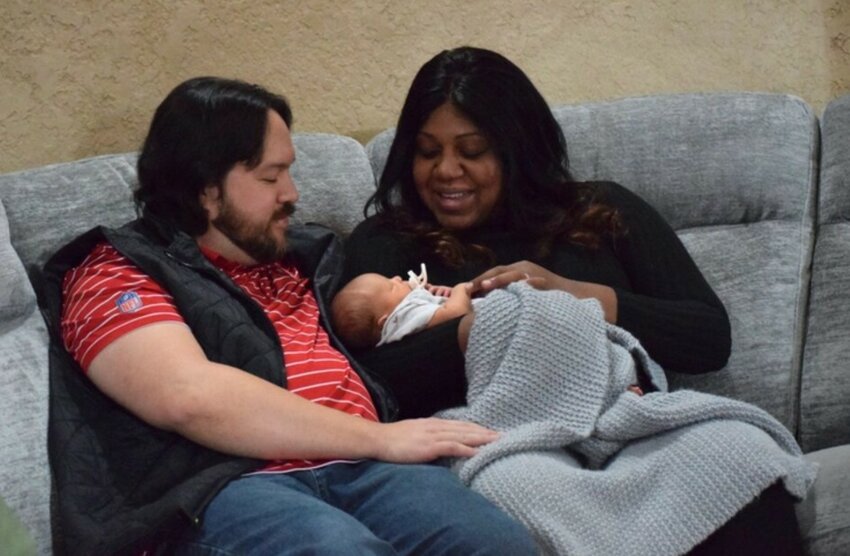 A couple sits with their newborn inside their Bentonville, Arkansas, home earlier this month. Nearly a quarter of pregnant women aren&rsquo;t getting prenatal care in the early stages of pregnancy, according to a new analysis from the U.S. Centers for Disease Control and Prevention.