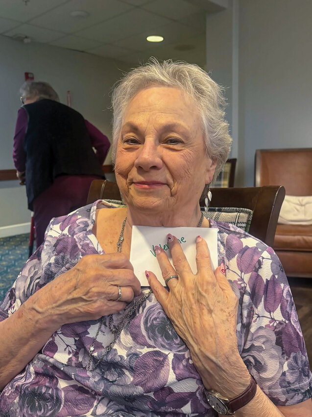 A senior hugs a Valentine&rsquo;s Day card with a wide smile. Battle Ground Senior Citizens Inc. volunteers delivered hundreds of cards to two local assisted living residents ahead of Valentine&rsquo;s Day 2026.
