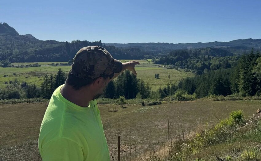 Brent Mahitka gestures across the Skamokawa Valley on Aug. 21, 2025, towards prime hunting lands that have seen access curtailed by gates over the years.