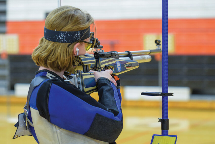 Battle Ground High School junior and second lieutenant Tanahleigh Boomhower aims at a target during precision air rifle practice. Boomhower helped lead the team that contributed to the school&rsquo;s Columbia River Division championship this season.