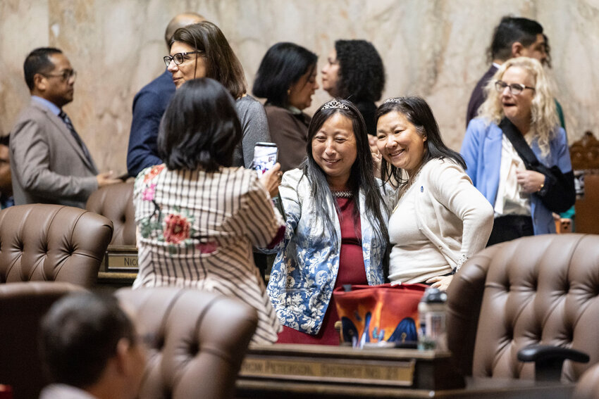 Representatives take a photo wearing tiaras to celebrate the last day of the legislative session on the House floor on Thursday, March 12, in Olympia.