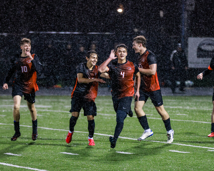 Battle Ground senior boys soccer captain Bryland Fick, No. 4, celebrates his first of two goals with his teammates in the Tigers&rsquo; 4-3 win against Mountain View High School on Wednesday, March 11.