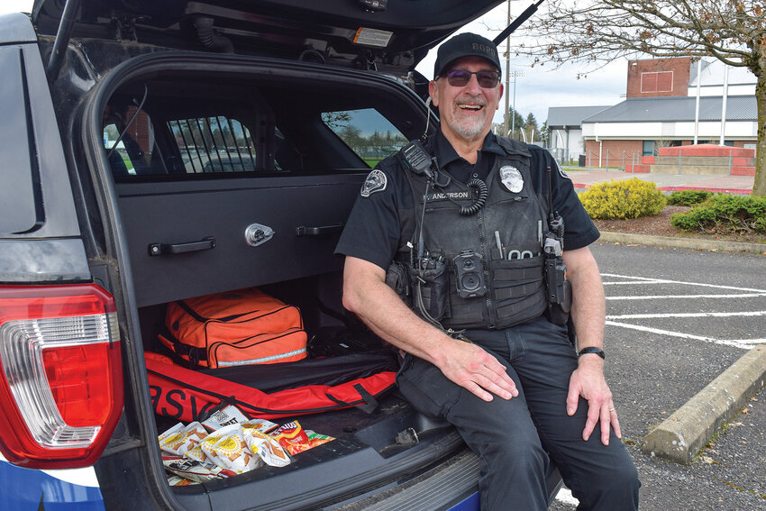 Battle Ground Police Department School Resource Officer Phil Anderson sits in the back of a patrol vehicle by Battle Ground High School. The vehicle will be filled with donated snacks during the Cram the Cruiser event to support student pantries at Battle Ground High School and Prairie High School. The event will be held from 11 a.m. to 3 p.m. at Fred Meyer, 401 NW 12th Ave., in Battle Ground on Saturday, March 28.