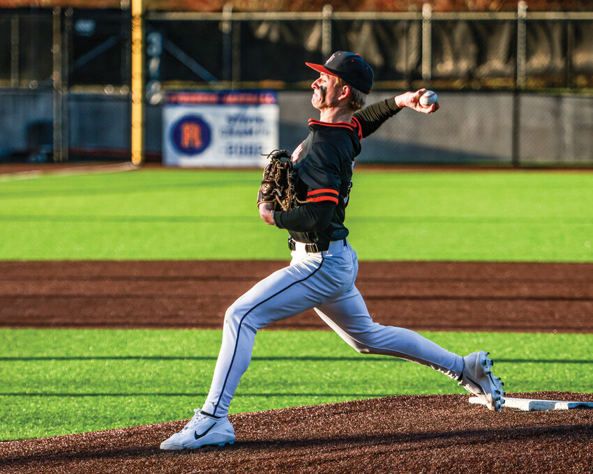 Battle Ground senior Axel Massie fires in a pitch during his four innings of relief during the Tigers&rsquo; 10-5 win over Ridgefield High School on Wednesday, March 25.
