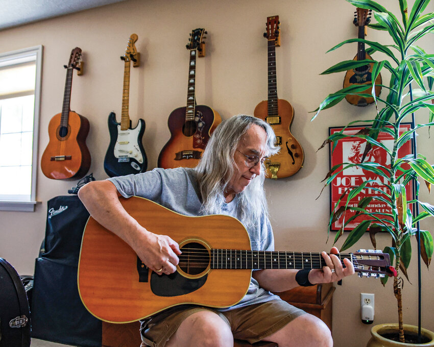 Battle Ground musician Dan Dingman plays his 1972 Martin D-28 in his home in July  2025.