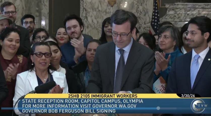 Gov. Bob Ferguson signs a bill on March 30, 2026, that will notify immigrant workers when a federal agency announces an upcoming inspection of the business&rsquo; I-9 forms on file. Employers use the I-9 and related documents to verify employees&rsquo; identity and work authorization. Courtesy: TVW