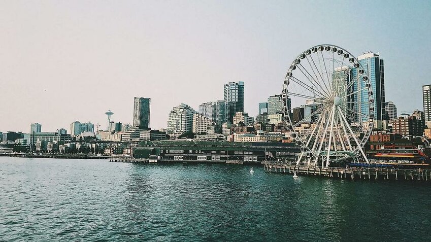 The Seattle waterfront and Ferris wheel are seen along Elliott Bay in Seattle, Washington.