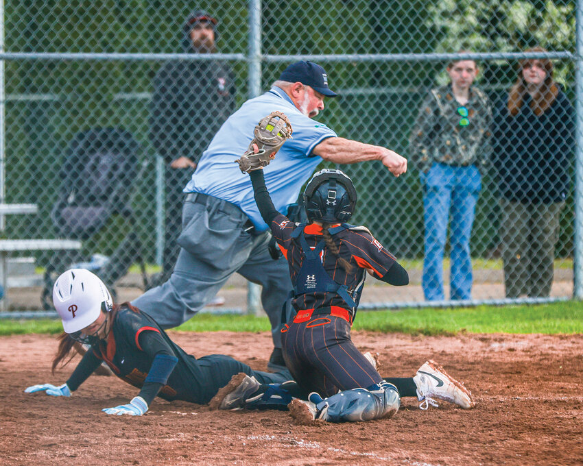 Battle Ground catcher McKenna Fields holds the ball up after recording a seventh inning out at home plate assisted by Delyla Gruenberg in a fielder&rsquo;s choice play. The Prairie Falcons ultimately got the 7-6 win over the Battle Ground Tigers on Thursday, April 2.
