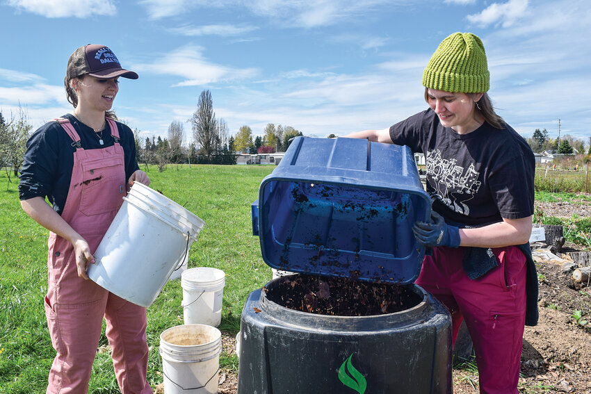 Clark County Public Works Environmental Outreach Specialist Shannon Hunter, left, and volunteer Hill Andersen fill a compost bin with brown leaves at Heritage Farm last week. Public Works will soon host spring workshops to teach gardeners the basics of composting.