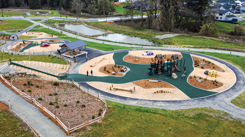 An aerial view shows Storybook Hollow Park, its surrounding natural areas and nearby development. The park is the first phase of a planned 15-acre community space in the Paradise Pointe neighborhood.