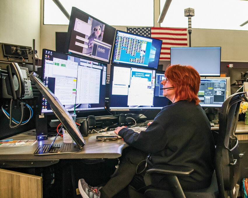 Robin Donahue, a CRESA 911 dispatcher, works at her desk inside the call center in Vancouver on Thursday, March 26.