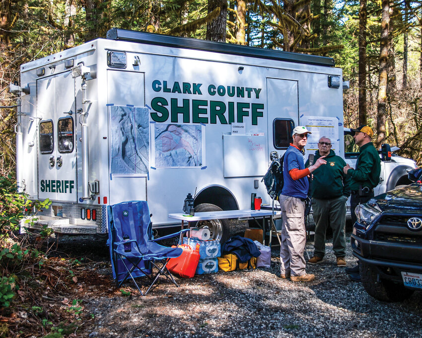 Search and rescue volunteers and Clark County Sheriff&rsquo;s Office Cold Case workers talk at the command post during a search for the remains of a missing victim of serial killer Warren Forrest on Saturday, April 4.