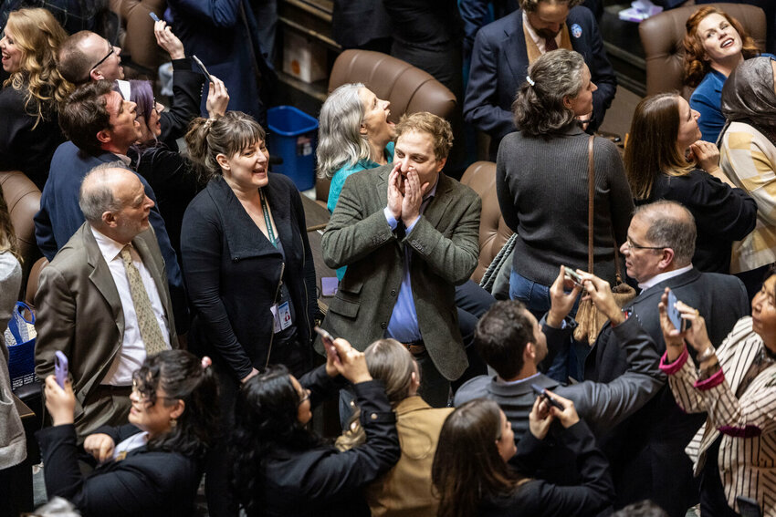 Lawmakers, friends and families celebrate the final gavel on the last day of the legislative session on the House floor on Thursday, March 12, in Olympia.