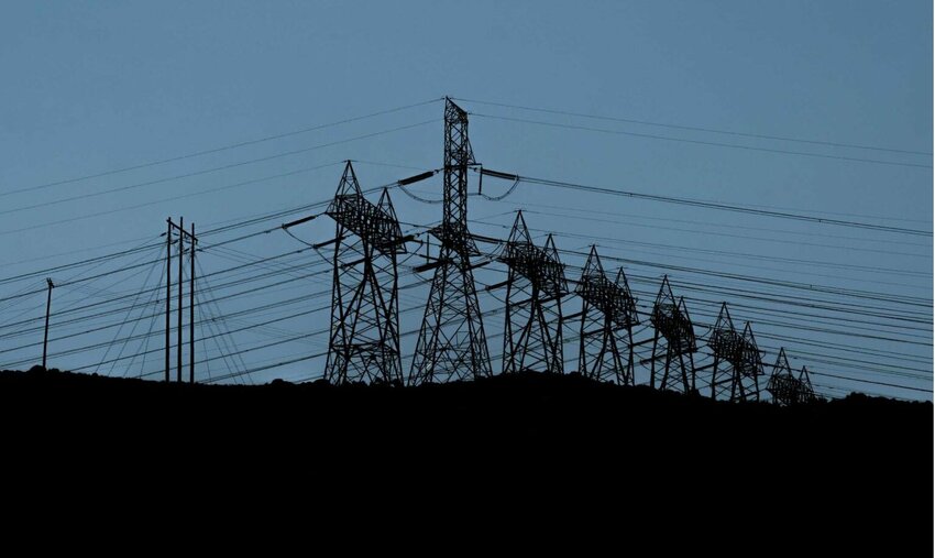 Powerlines above the Columbia River move electricity from the Bonneville Dam to customers across the region in Hood River County, Oregon, on Thursday, July 25, 2024. (Jordan Gale/Oregon Capital Chronicle)