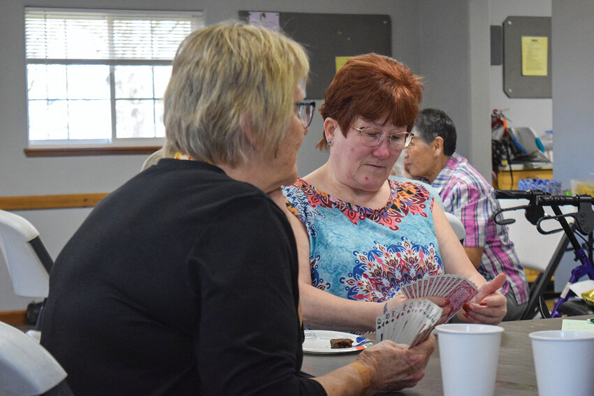 Local seniors gather around a table for a card game during Senior Fun and Games at the Woodland Community Center last week. The Woodland Senior Enrichment Group recently secured consistent three-day-a-week access to the center and received lodging tax funding to support upcoming community events.