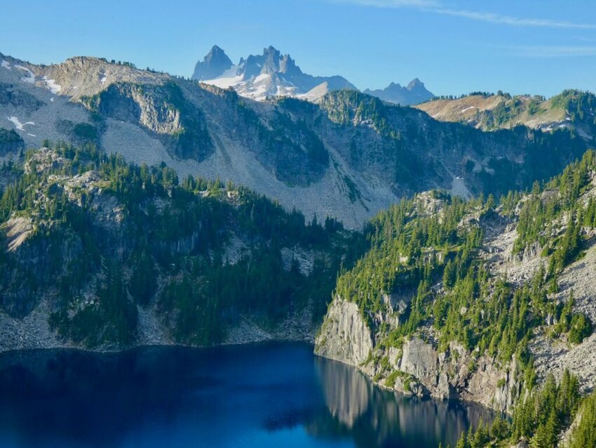Angeline Lake reflects nearby mountains in the Mount Baker-Snoqualmie National Forest in Washington state. The U.S. Forest Service will be undergoing a major reorganization. (Photo by Alex Brown/Stateline)