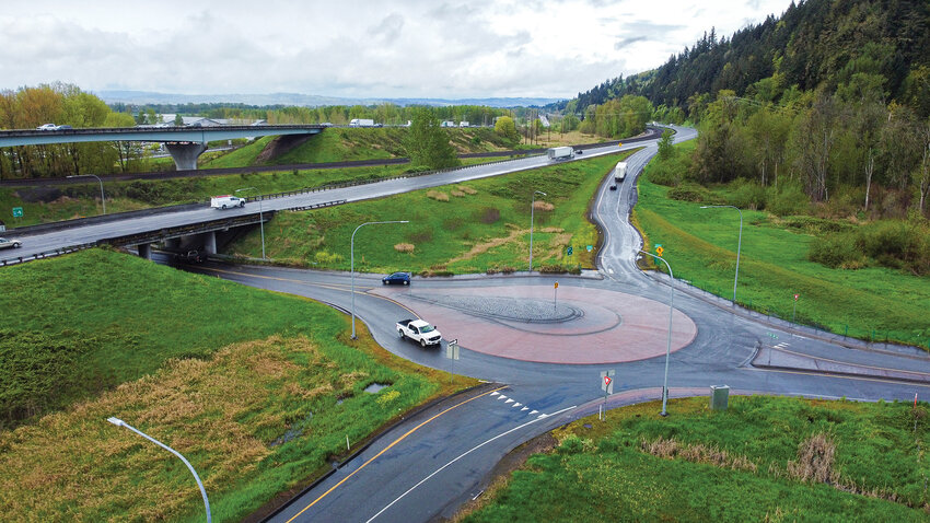 Vehicles move through the roundabout connecting the northbound Interstate 5 ramps to Dike Access Road in Woodland, east of the overpass. The intersection is part of Exit 22, now under review for congestion mitigation as the city advances the Exit 21 project.