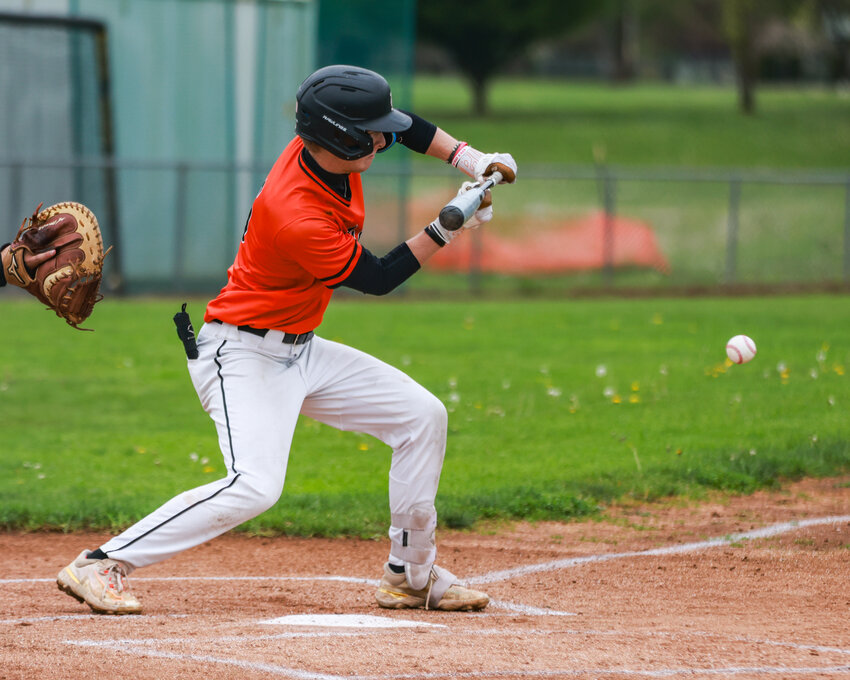 Battle Ground&rsquo;s Trenton Righter drops a bunt for a base hit in the first inning of Tigers&rsquo; 6-0 win over the Skyview Storm on Thursday, April 23.