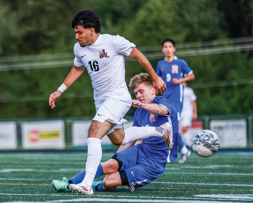 Ridgefield senior Zeke Adams makes a diving tackle at the ball during the Spudders&rsquo; 3-0 win over R.A. Long High School on Friday, May 1.
