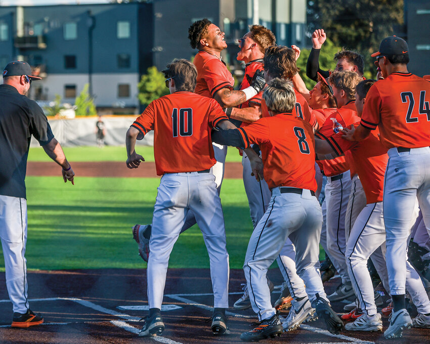 Battle Ground senior James Gill III is mobbed at home plate after a two-run walk-off home run to take the 4A Greater St. Helens League title 6-5 over the Union Titans on Thursday, April 30.