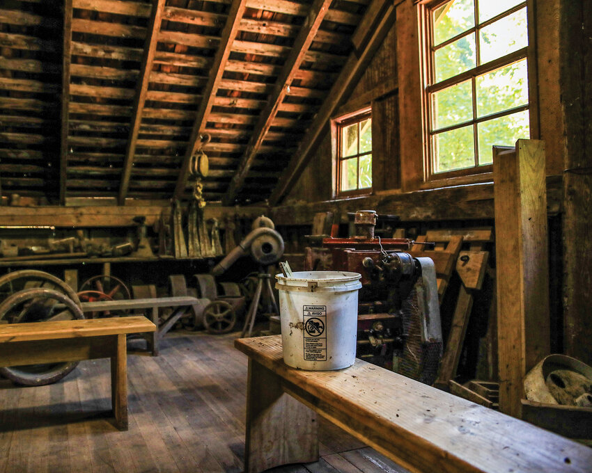 One of many buckets upstairs in the Cedar Creek Grist Mill on Wednesday, April 29, is used to collect water from the leaking roof as repairs are in dire need to preserve the historic structure.