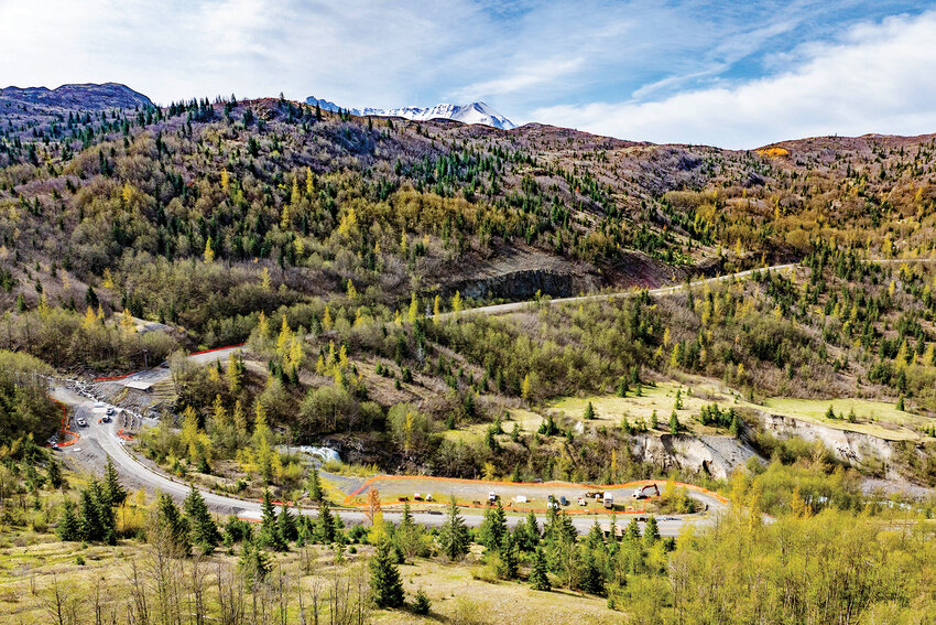 Work crews and equipment are shown by way of aerial photo on Spirit Lake Memorial Highway near mile marker 49 on Thursday, April 30. This section of the highway has been closed since May 14, 2023, when more than 300,000 cubic yards of debris slid around 2,000 feet down the hillside and destroyed the bridge.