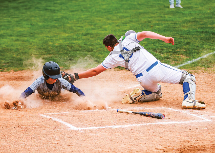 La Center catcher Chase Henderson applies a tag just a tad late on the game&rsquo;s only score in the Wildcats&rsquo; 1-0 loss to the Seton Catholic Cougars on Tuesday, May 5.