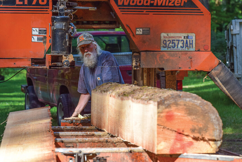 Brian Trembley adjusts a log on his portable sawmill before cutting it into planks at Lewisville Park on Thursday, May 7. The lumber produced during the project will eventually support Clark County park projects, including benches, tables and rails.