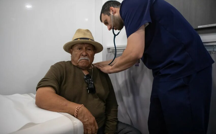 A man gets a checkup at the Saint Agnes Mobile Health Unit mobile clinic parked at the City Heritage Park in Parlier, Calif., on May 16, 2025. California is one of at least five states plus the District of Columbia that have scaled back state-funded healthcare coverage in response to federal Medicaid cuts and the expiration of Obamacare subsidies.