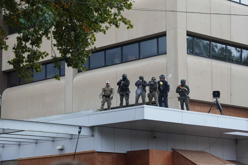 Federal officers shoot pepper balls at protestors at the ICE facility south of downtown Portland on Sunday, Oct. 12, 2025. (Photo by Alex Baumhardt/Oregon Capital Chronicle)