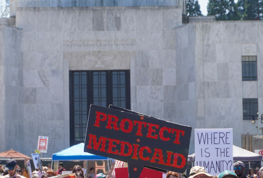 A person holds a &ldquo;Protect Medicaid&rdquo; sign in front of Oregon State Capital in Salem on May 1, 2025.