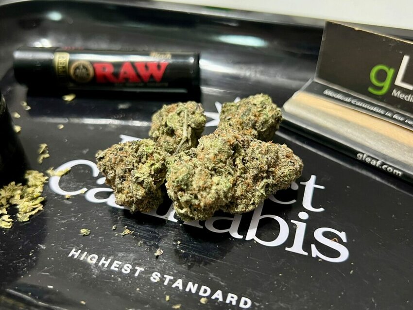 Cannabis flower rests on a rolling tray, surrounded by a pack of rolling papers, a grinder and a lighter. Lawmakers in a handful of states this year have introduced legislation to impose stricter THC limits on certain cannabis products.