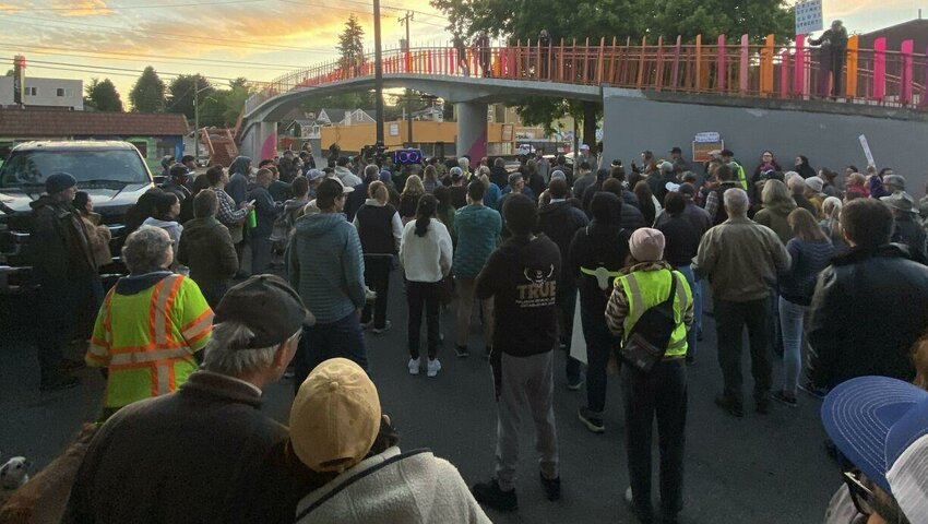 Marchers listen to a speaker following walking North Seattle's Aurora Avenue to protest crime in the neighborhood. Former Seattle City Attorney Ann Davison helped organize the event.