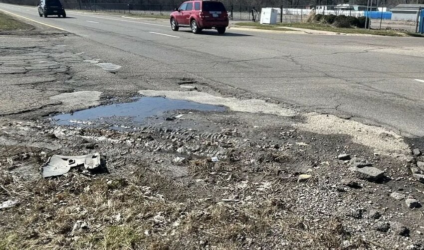 A pothole and crumbling road.