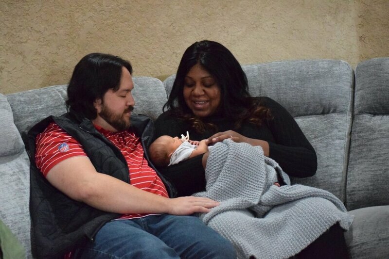 A couple sits with their newborn inside their Bentonville, Arkansas, home. The Trump administration is shifting the federal Title X program, which has traditionally provided access to contraception, toward an emphasis on childbearing.