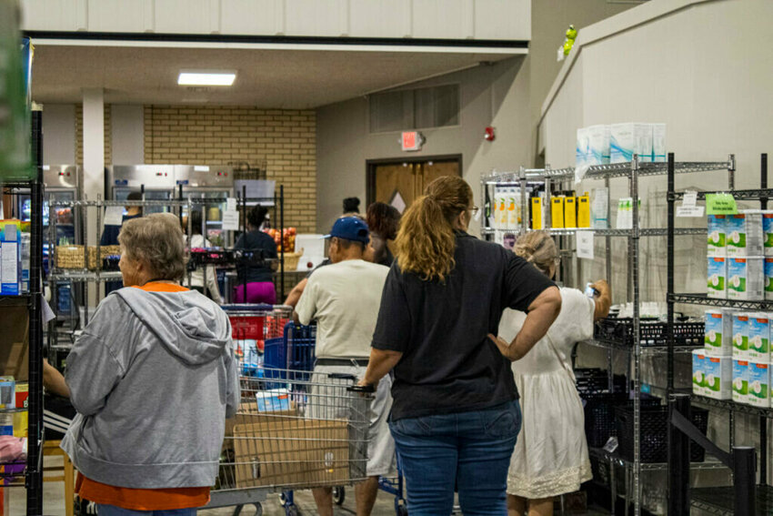 People shop the shelves at the Ritenour Co-Care Food Pantry just outside of St. Louis last week. The nonprofit has seen rising need as grocery prices soar and thousands of Missourians lose federal food assistance.