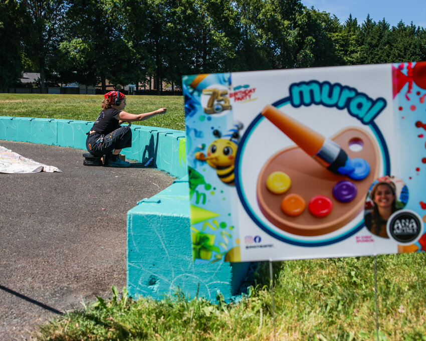 Local artist Ana Gabriela Honsowetz works on a mural in front of attendees to the city of Battle Ground&rsquo;s 75th anniversary pop-up party at Kiwanis Park on Thursday, June 18.