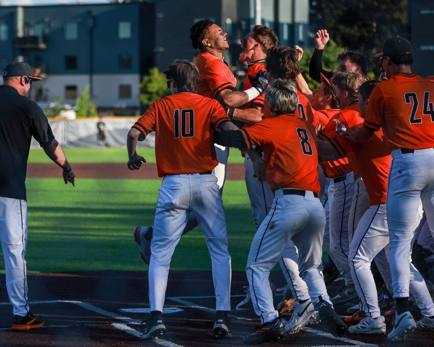 Battle Ground senior James Gill III is mobbed at home plate after a two-run, walk-off home run to take the 4A Greater St. Helens League title 6-5 over the Union Titans on Thursday, April 30.