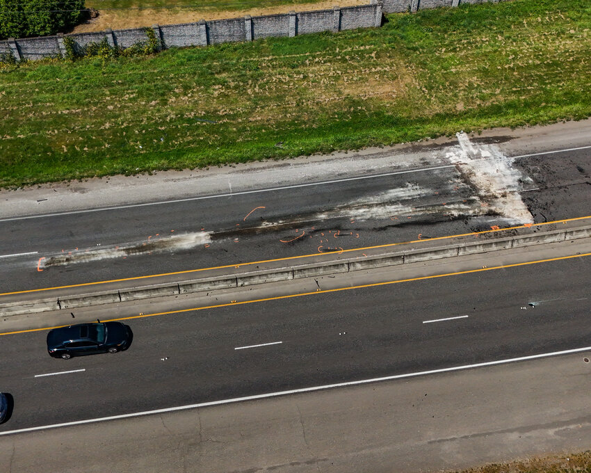 Fire markings and investigation paint fill the pavement of state Route 503 just north of Northeast 179th Street in Battle Ground following a wrong-way, head-on collision early Sunday, July 5, that killed three people and injured one.