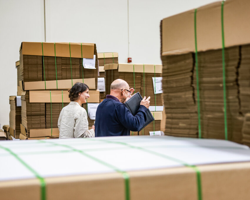 U.S. Rep. Marie Gluesenkamp Perez, D-Skamania, left, smiles while touring the Northwest Paper Box manufacturing facility in Camas with CEO Brad Van Allen on Thursday, July 9.